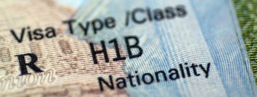 Storm clouds with a WARNING road sign in front of them.
