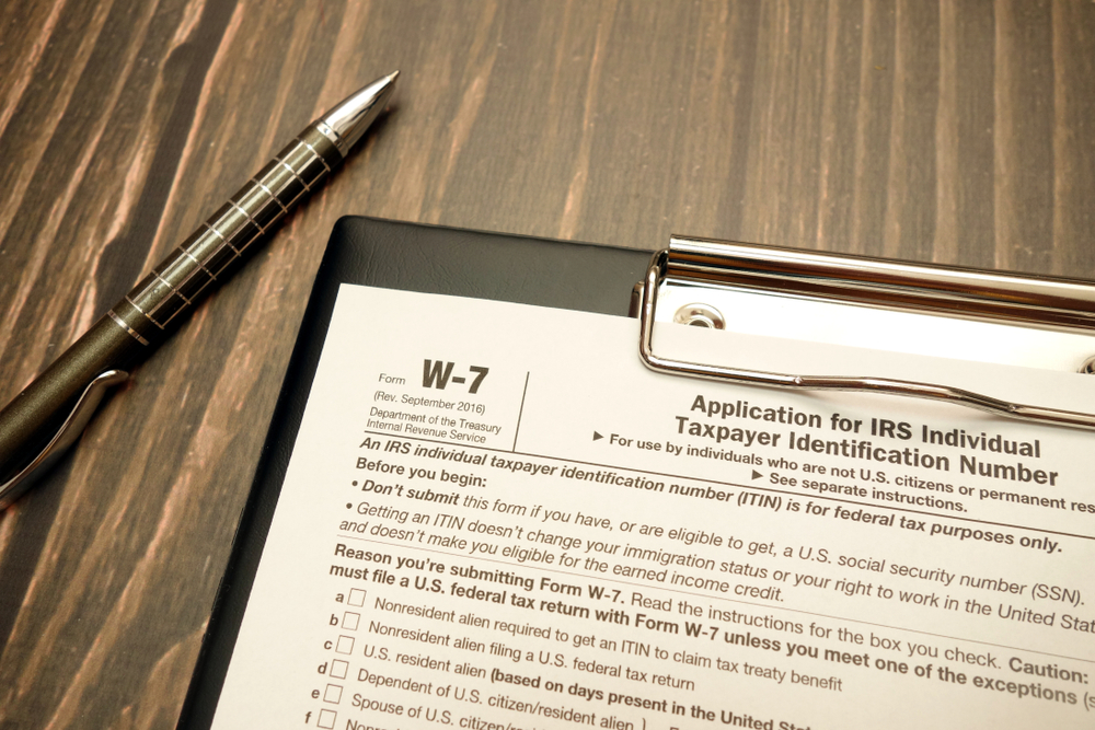 Image of a tax form on a clipboard with a pen.